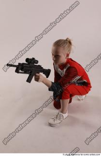 DENISA KNEELING POSE WITH GUN